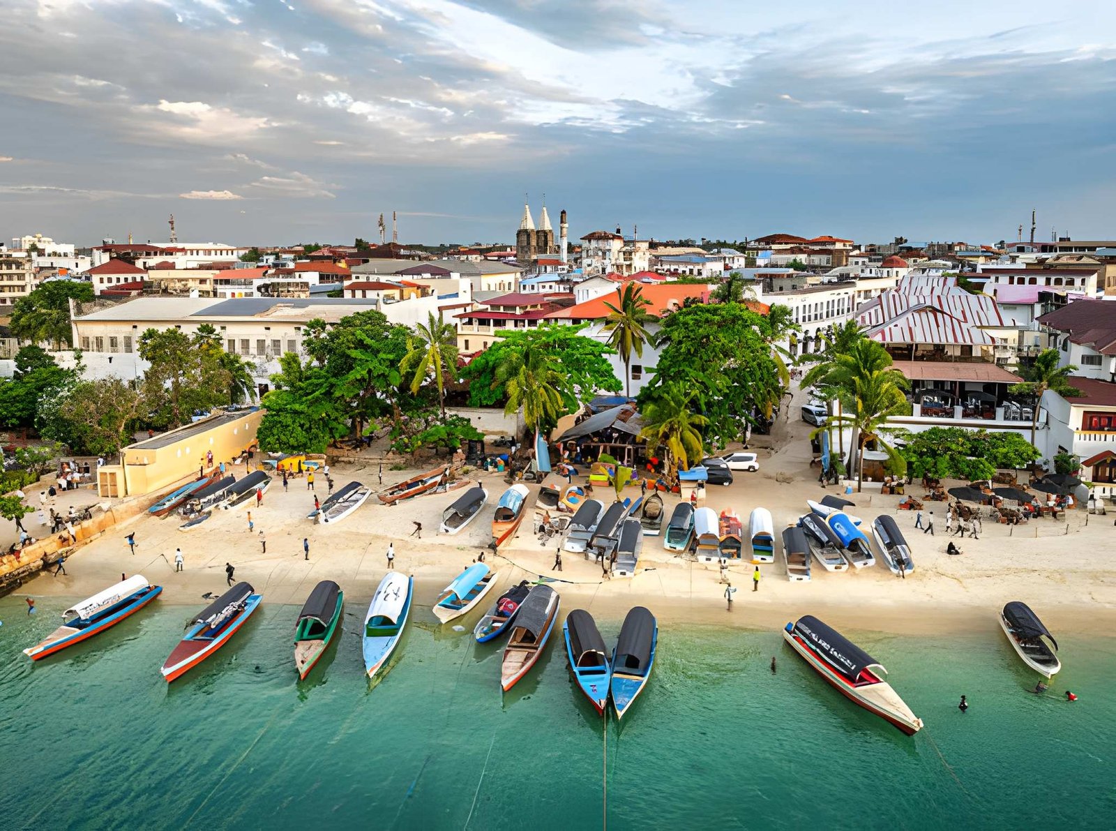 Aerial view of Stone Town coast showing colorful boats anchored along the shoreline and historic buildings.
